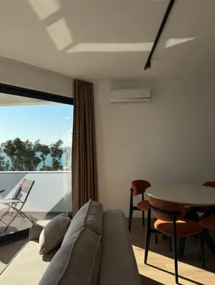 a living room with a couch and a table at Seaview Komina apartments in Bar