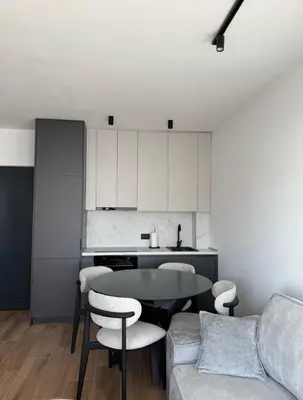 a living room with a table and a couch at Seaview Komina apartments in Bar