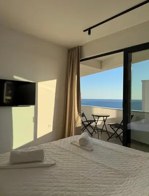 a bedroom with a bed and a view of the ocean at Seaview Komina apartments in Bar