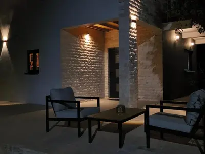 a patio with two chairs and a table at night at Braća Velić in Bar