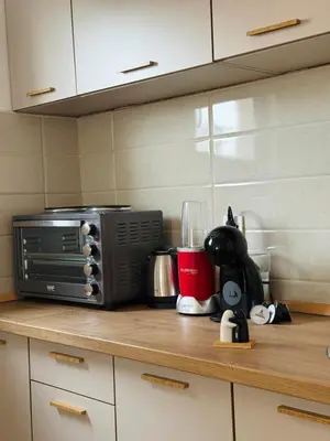 a kitchen counter with a microwave on top of it at Comfort corner Podgorica in Podgorica