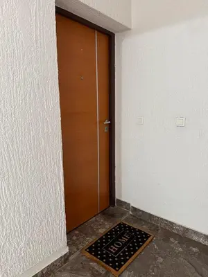 a door in a room with a mat in front of it at Comfort corner Podgorica in Podgorica