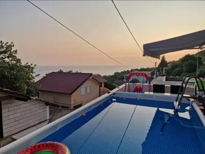 a swimming pool on the roof of a house at Apartmani Kruče in Ulcinj