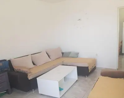 a living room with a couch and a table at Apartmani Kruče in Ulcinj