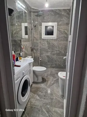 a bathroom with a toilet sink and a shower at Apartmani Kruče in Ulcinj