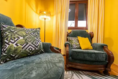 a living room with a chair and a lamp at Apartment Mia in Podgorica