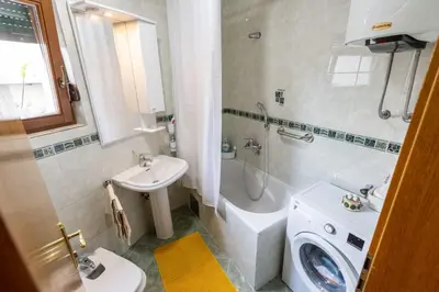 a bathroom with a sink and a toilet and a shower at Apartment Mia in Podgorica