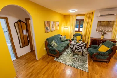 a living room with two chairs and a table at Apartment Mia in Podgorica