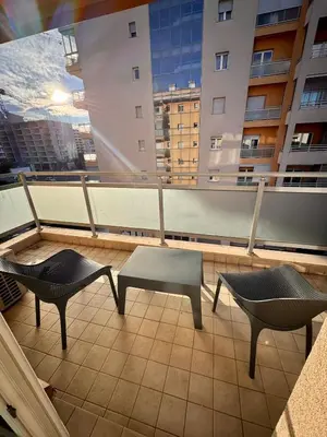 two chairs and a table on a balcony at Bright & Modern Apartment in City Kvart in Podgorica