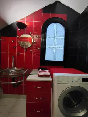 a bathroom with a washing machine and a sink at Katata Apartment in Podgorica