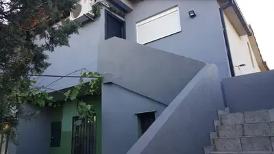 a building with a staircase leading up to a window at Katata Apartment in Podgorica