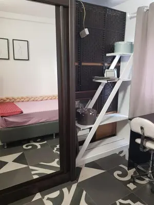 a room with a mirror and a bed and a shelf at Katata Apartment in Podgorica