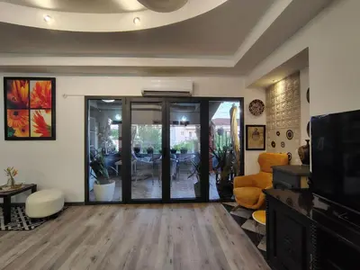 a living room with a sliding glass door at Katata Apartment in Podgorica