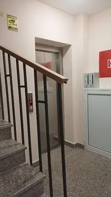 an elevator in a building with a stair case at Central Sea View Studio Budva in Budva