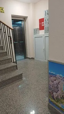 a hallway with a staircase and a door with a door at Central Sea View Studio Budva in Budva