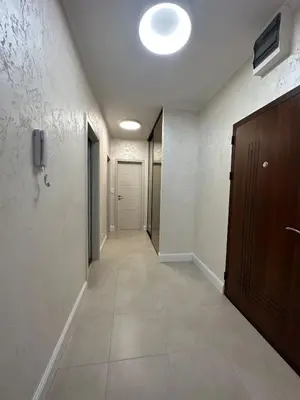 an empty hallway with a door and a phone on a wall at ViSi 10 in Podgorica