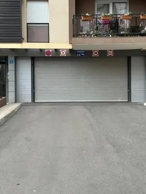 two garage doors in front of a building at ViSi 10 in Podgorica