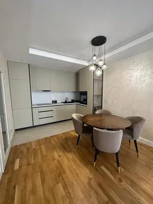 a kitchen and dining room with a table and chairs at ViSi 10 in Podgorica