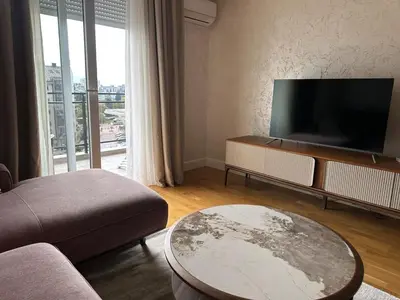 a living room with a tv and a couch and a table at ViSi 10 in Podgorica