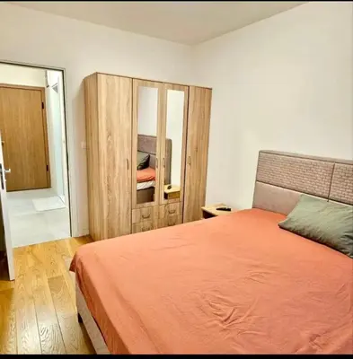 a bedroom with a bed and a mirror at Mia Suites in Podgorica