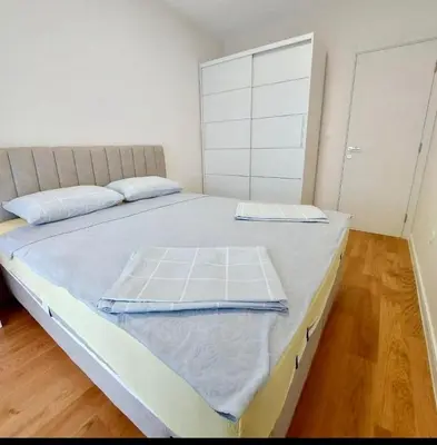 a bedroom with a large bed with two pillows on it at Mia Suites in Podgorica