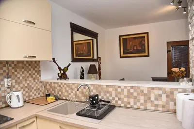 a kitchen with a sink and a counter top at Aky apartment in Škaljari