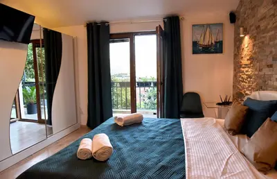a bedroom with a bed with two slippers on it at Aky apartment in Škaljari