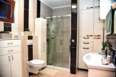 a bathroom with a shower and a toilet and a sink at Aky apartment in Škaljari