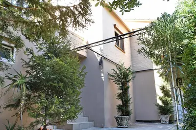 a house with trees in front of it at Aky apartment in Škaljari