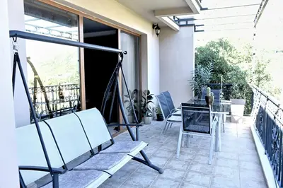 a patio with a table and chairs on a balcony at Aky apartment in Škaljari