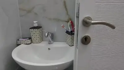 a bathroom with a white toilet and a sink at Apartment Pinješ in Ulcinj