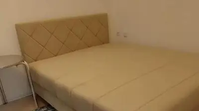 a large bed in a small room with aermottermott at Apartment Pinješ in Ulcinj