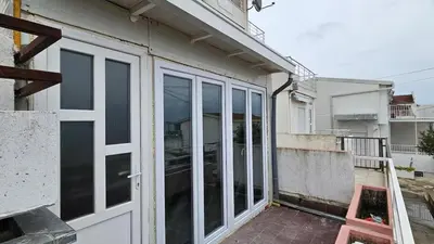 a sliding glass door on the side of a building at Apartment Pinješ in Ulcinj