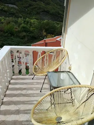 a couple of chairs sitting on a balcony at Apartman Blazo in Škaljari