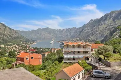 a view of a town with a lake and mountains at Apartman Blazo in Škaljari
