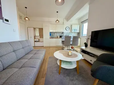 a living room with a couch and a table at Comfortable City Apartment in Bar