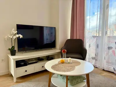 a living room with a television and a coffee table at Comfortable City Apartment in Bar