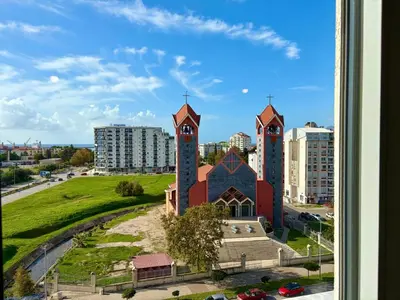 a church with two towers in a city at Comfortable City Apartment in Bar