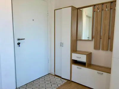 a bathroom with a white door and a mirror at Comfortable City Apartment in Bar
