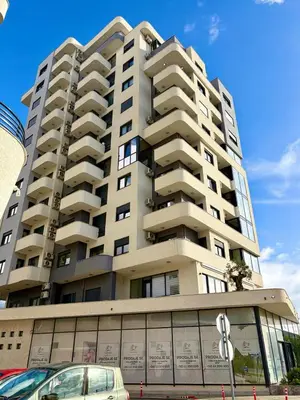 a tall building with a car parked in front of it at Comfortable City Apartment in Bar