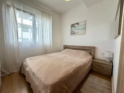 a small bedroom with a bed and a window at Comfortable City Apartment in Bar