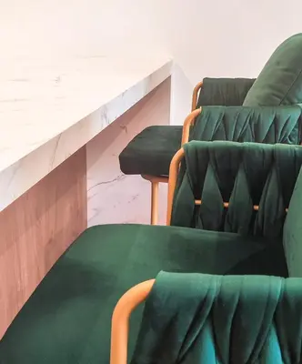 two green chairs and a table in a room at City Living with Style - Elegant One-Bedroom Apartment in Podgorica