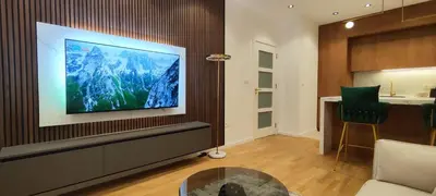 a living room with a flat screen tv on a wall at City Living with Style - Elegant One-Bedroom Apartment in Podgorica