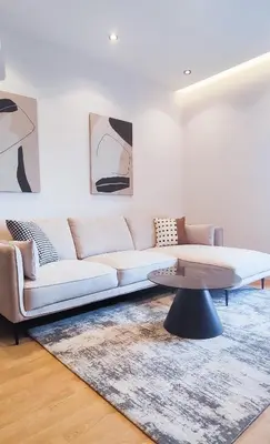 a living room with a couch and a coffee table at City Living with Style - Elegant One-Bedroom Apartment in Podgorica