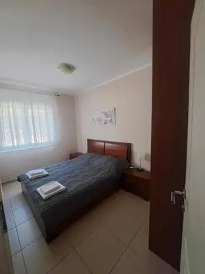 a bedroom with a bed with two towels on it at Apartman 3D in Podgorica