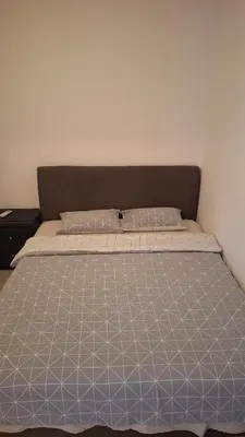 a bedroom with a bed with a blue and white comforter at Simpi in Pržno