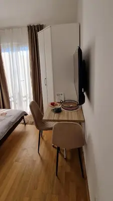 a room with a table with a television and a bed at Mirko's home 2 Studio Apartment in Podgorica