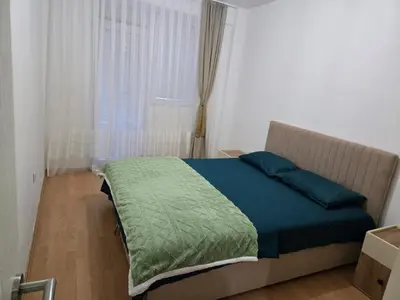 a bedroom with a bed with blue pillows and a window at Sena in Bar