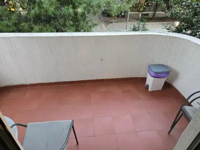 a patio with two chairs and a trash can at Sena in Bar