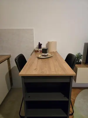 a wooden table with chairs and a cup of coffee on it at Sena in Bar